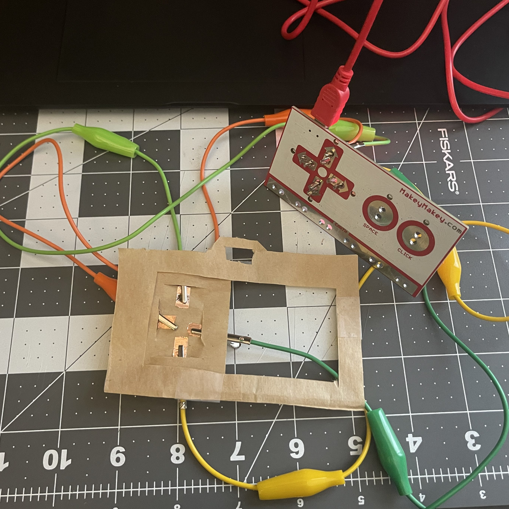 This is the paper prototype hooked up to the makey makey. I added little slits for the copper tape so it was easier to use the prototype. The idea behind it is that the prototype goes on top of the makey makey to simulate a moveable camera.