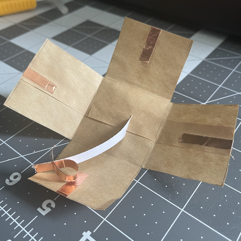 This is the paper bag prototype of a fold out dance floor. All I did was put on some copper tape on the edges. 