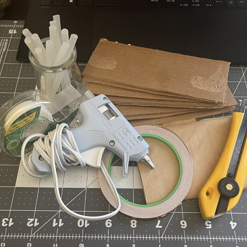 These were the materials I used for my miniature prototypes: Hot glue, cardboard pieces, tape, brown paper bags, copper tape, and a box cutter.